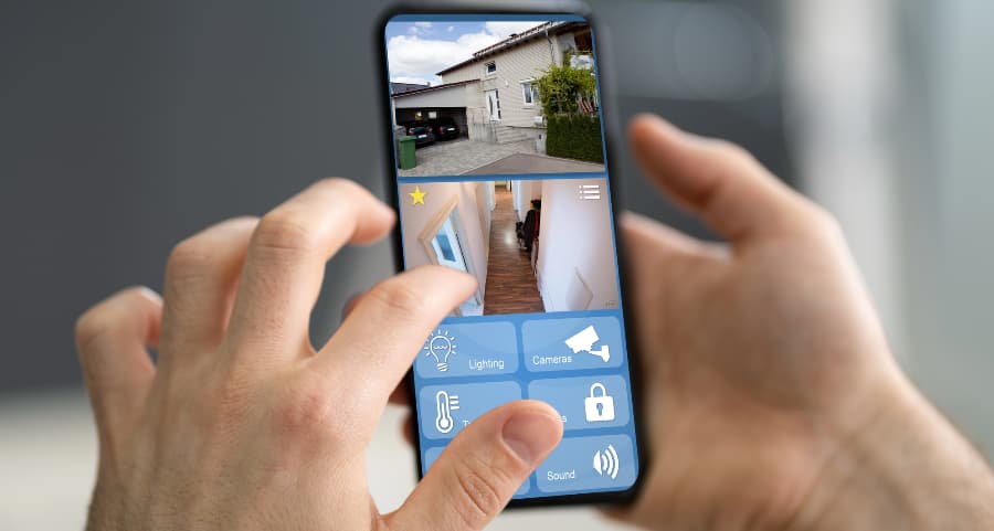 Homeowner looking at surveillance camera streams on a smartphone